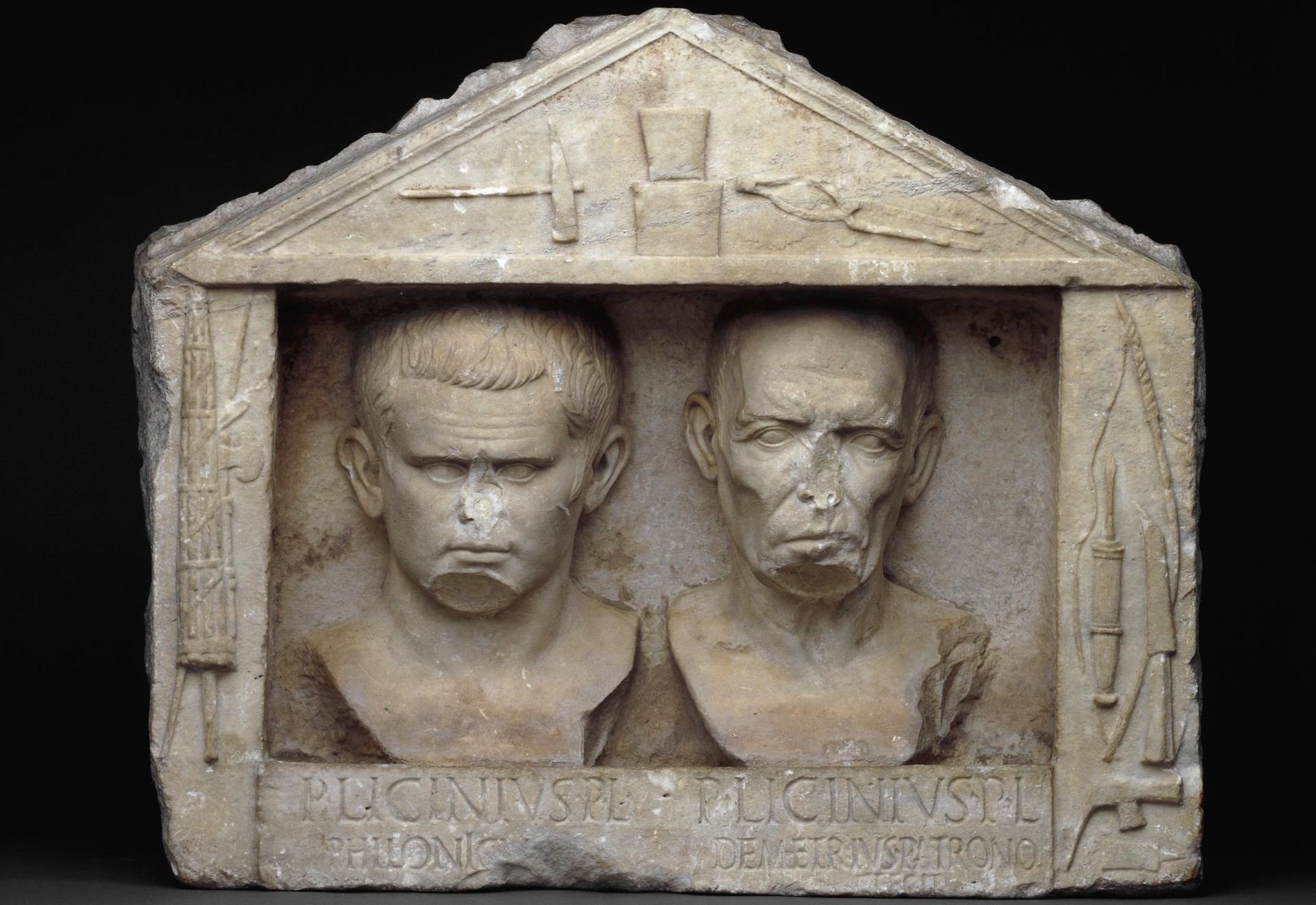 Funerary relief with portraits of the freedmen Publius Licinius Philonicus (a young smith) and Publius Licinius Demetrius (an old carpenter).